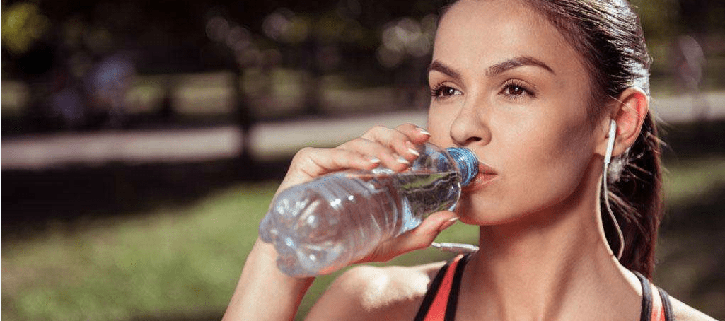 Doing exercises and drinking water Doing exercises and drinking water